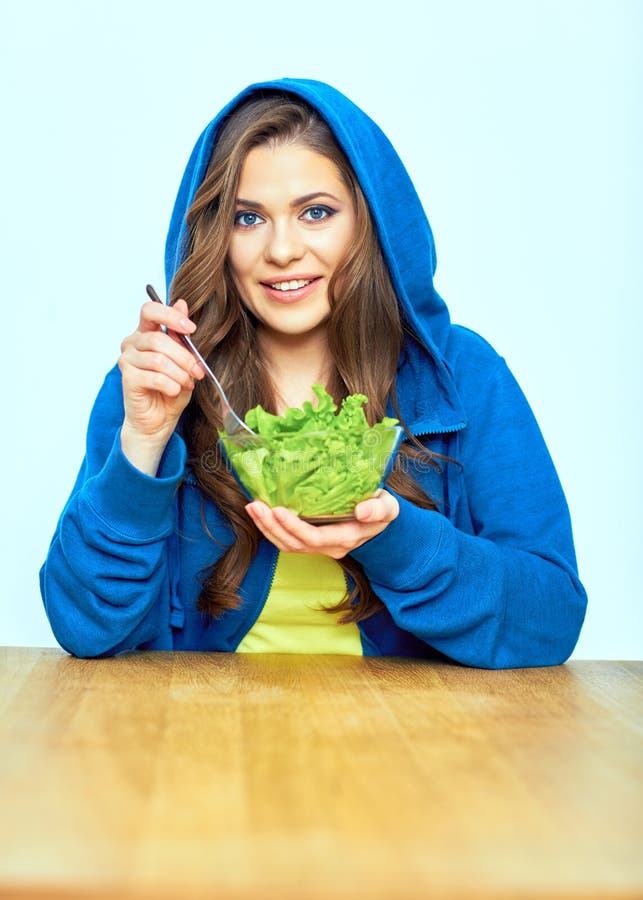 Portrait of woman eating salad.