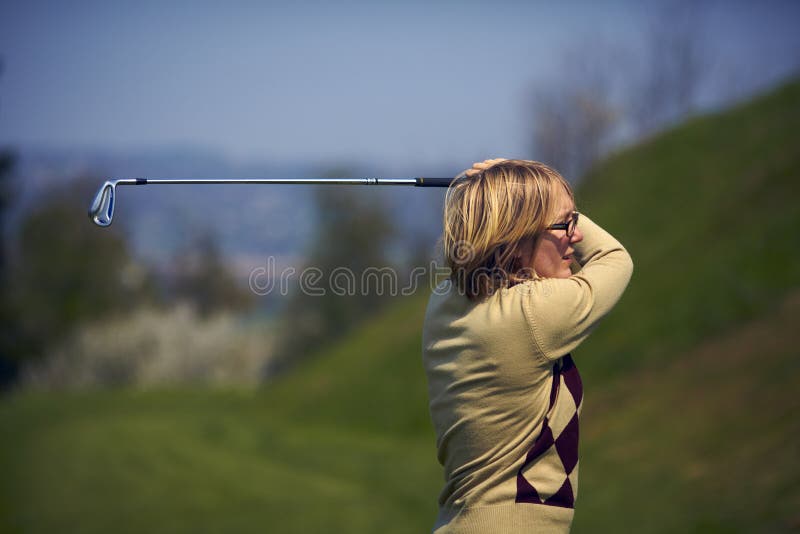 Portrait of woman golfer after a swing