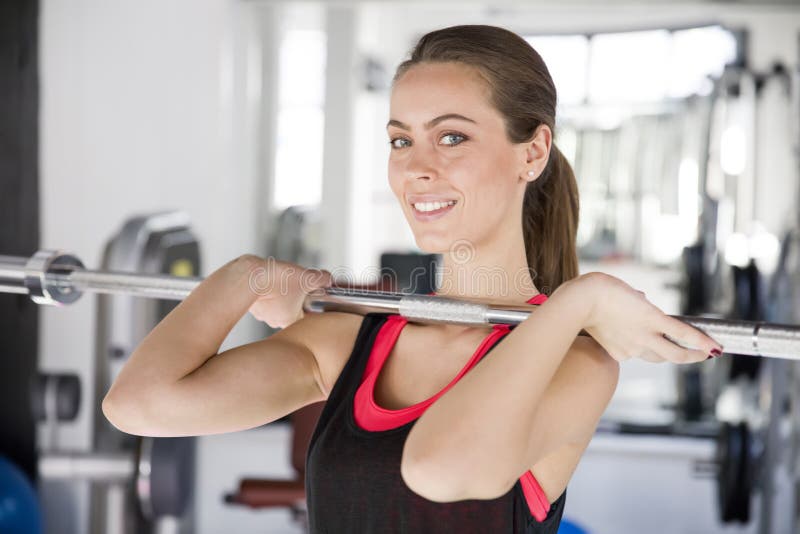 Portrait of a woman at the gym drinking water