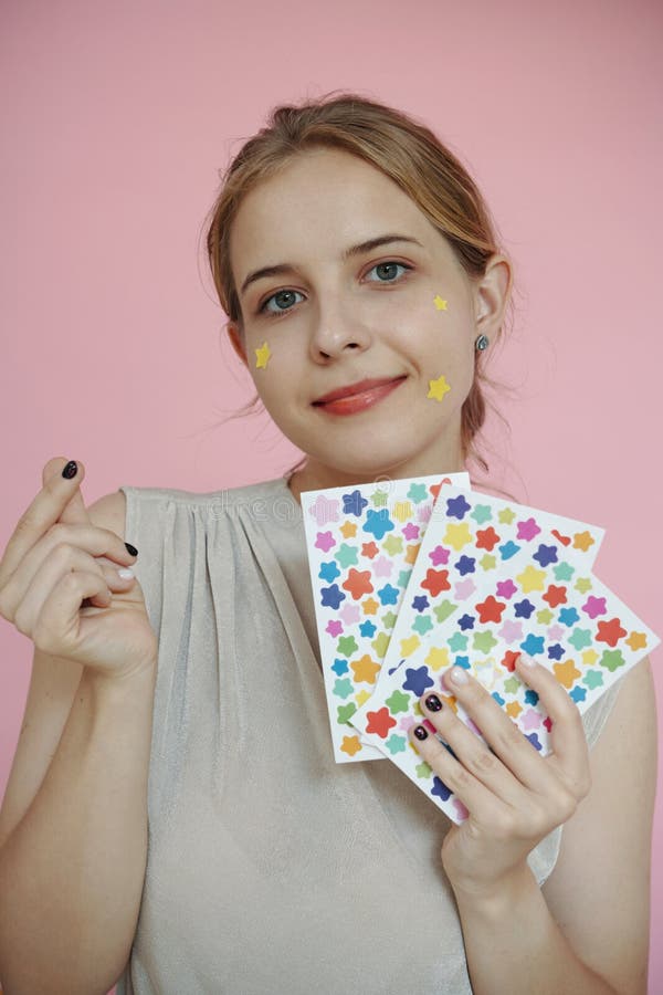 Portrait of Woman Holding Colorful Star Stickers royalty free stock photos