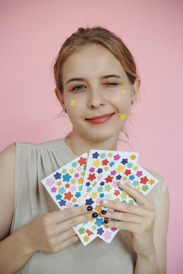 Portrait of Woman Holding Colorful Star Stickers stock photos