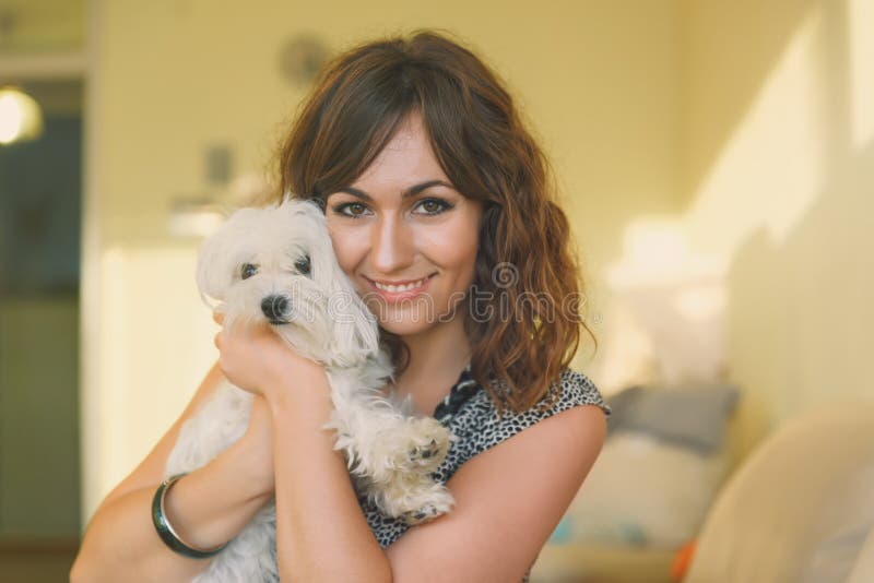 Portrait of Woman Hugging Small White Dog