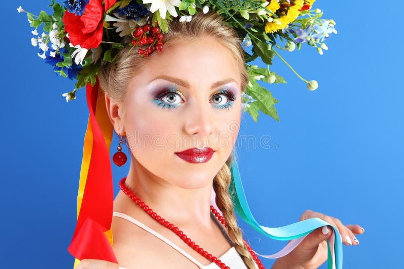 Portrait woman makeup with flowers on blue background stock photography Portrait woman makeup with flowers on blue background stock photography