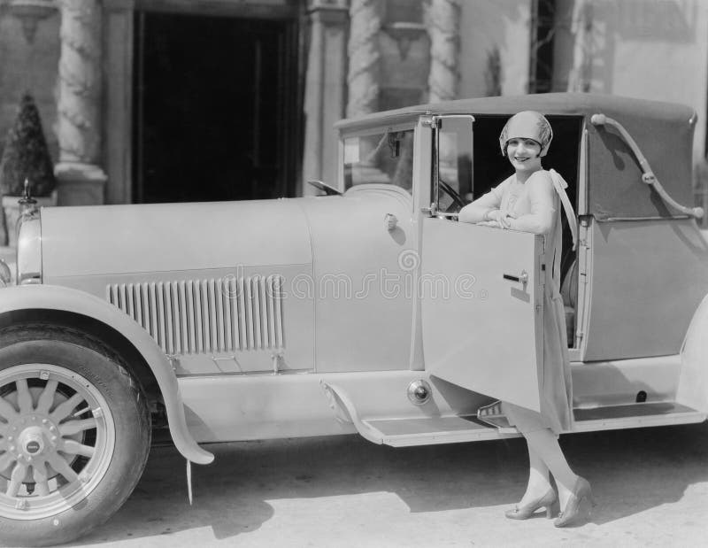 Portrait of woman posing with car