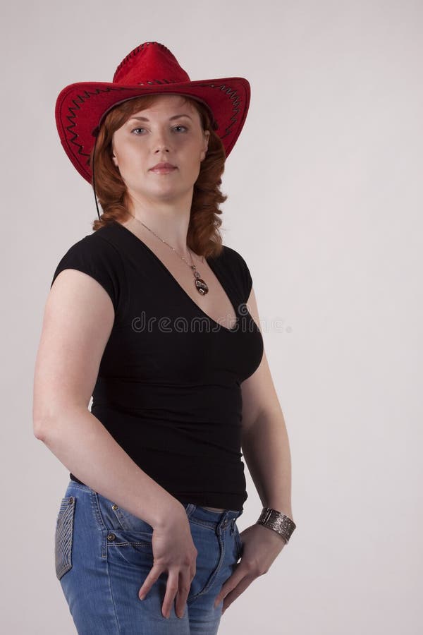 Portrait of the woman in a red cowboy s hat