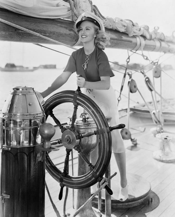 Portrait of woman steering boat stock photo Portrait of woman steering boat stock photo