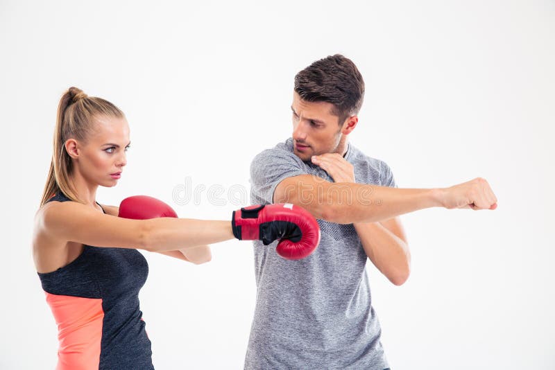 Portrait of a woman training boxing with coach