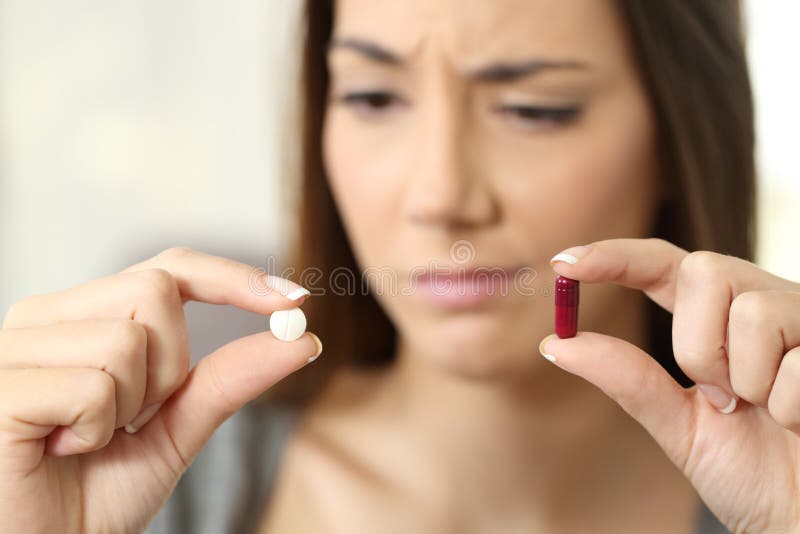 Woman wondering about pill or capsule