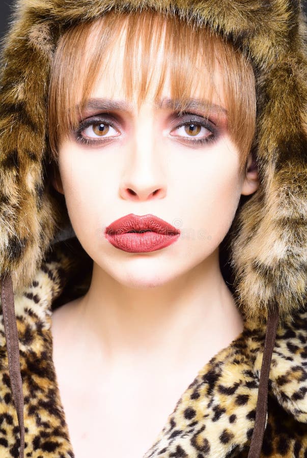Portrait of wonderful woman looking at camera. girl in leopard fur coat and hat stock image Portrait of wonderful woman looking at camera. girl in leopard fur coat and hat stock image