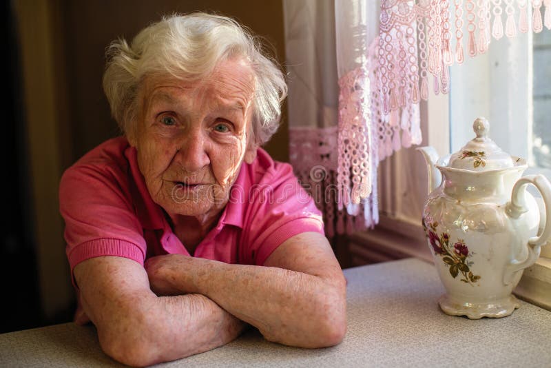 Portrait of a worried elder woman in the his house. Problem is raising the retirement age. Problem wrinkle stock images, royalty-free photos and pictures