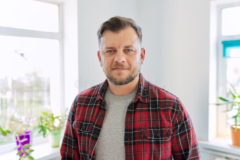 Portrait of 40 years old man, smiling male in plaid casual shirt looking at camera