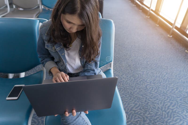 Portrait young Asian business woman working on laptop in airport royalty free stock images Portrait young Asian business woman working on laptop in airport royalty free stock images