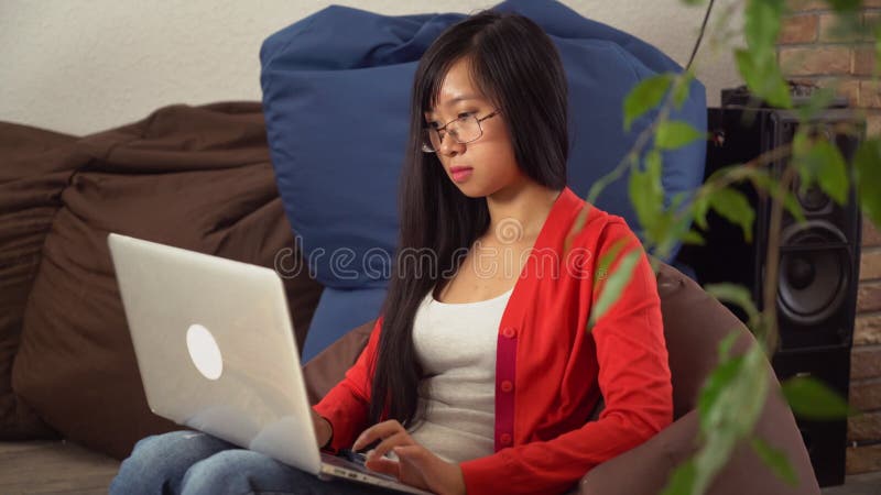 Portrait young asian girl looking with smile at the camera and chatting online