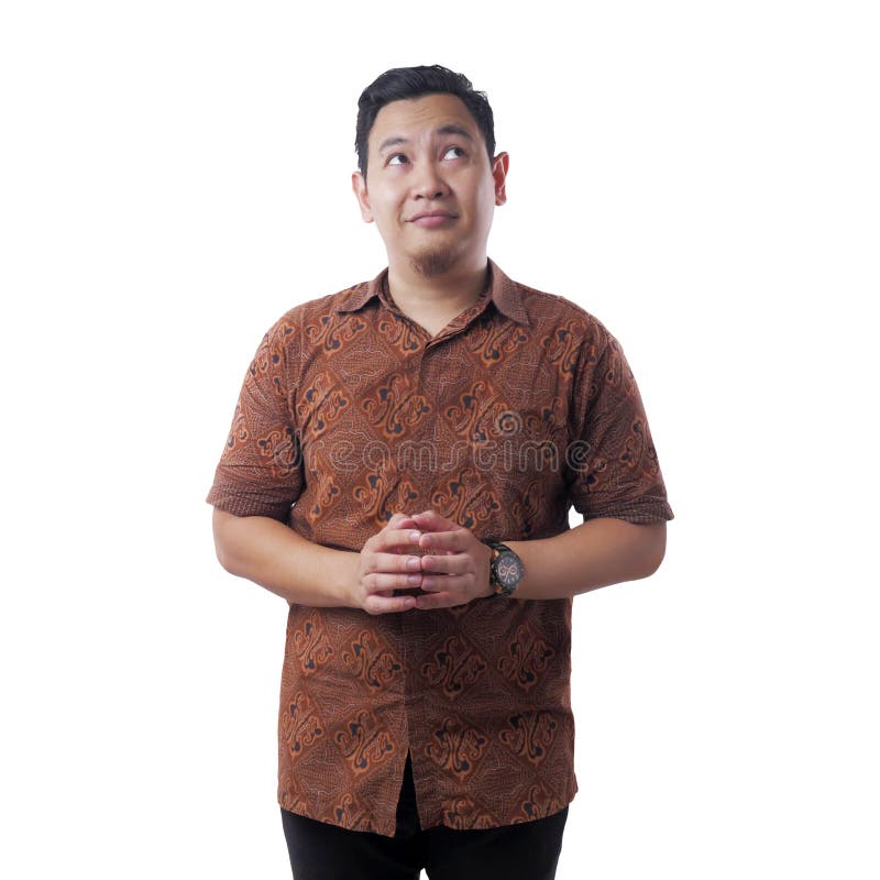 Portrait of young Asian man wearing batik shirt looked happy thinking and looking up, having good idea. Half body portrait isolated on white, above, adult, attractive, background, business, casual, concept, contemplating, copy, space, dreaming, expression, face, facial, guy, handsome, happiness, human, indonesian, malay, male, model, people, person, positive, problem, smile, smiling, solution, standing, thoughtful, traditional, upwards. Portrait of young Asian man wearing batik shirt looked happy thinking and looking up, having good idea. Half body portrait isolated on white, above, adult, attractive, background, business, casual, concept, contemplating, copy, space, dreaming, expression, face, facial, guy, handsome, happiness, human, indonesian, malay, male, model, people, person, positive, problem, smile, smiling, solution, standing, thoughtful, traditional, upwards