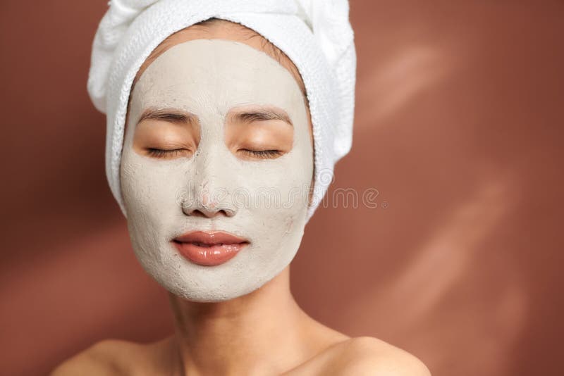 Portrait of Young Asian Wearing Clay Mask Over Brown Background Stock ...