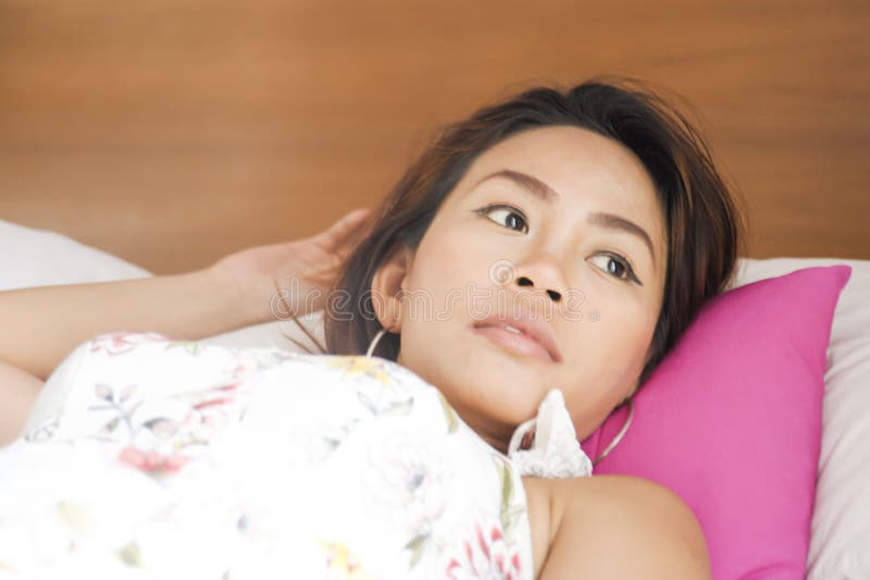 Portrait Of Young Attractive And Beautiful Asian Woman Lying On Bed At Bedroom In Sweet 