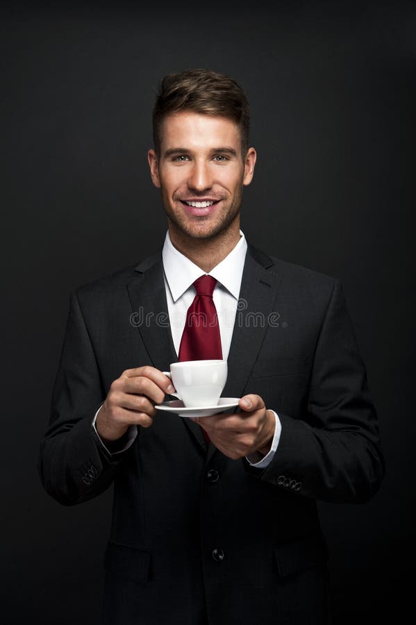 Portrait of Young attractive businessman drinking coffee