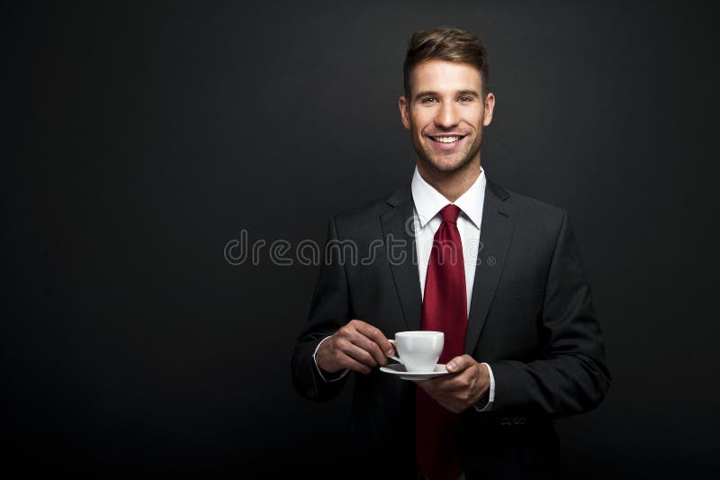 Portrait of Young attractive businessman drinking coffee