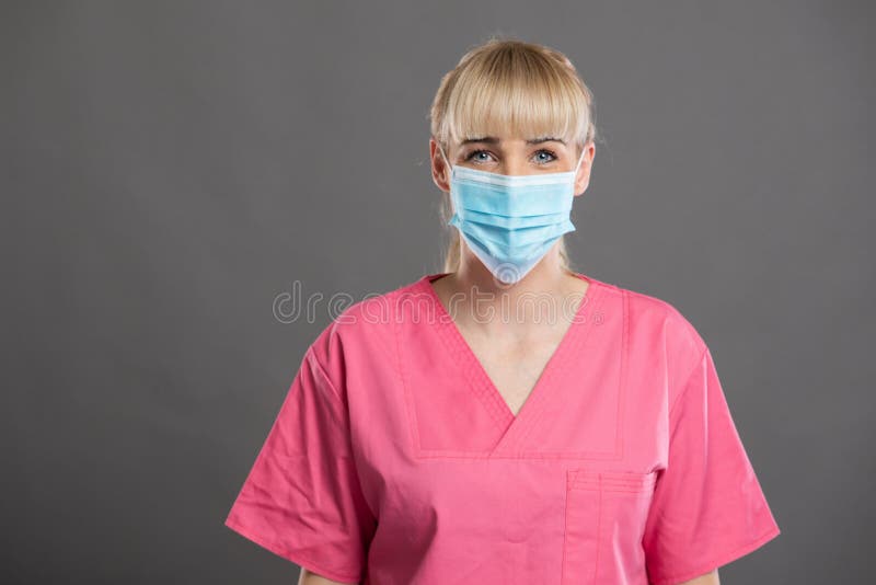 Portrait of young attractive female nurse wearing face mask