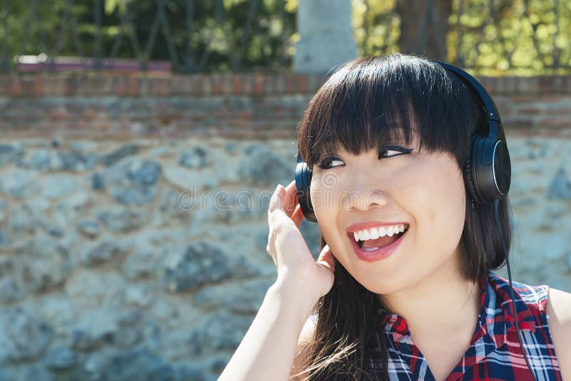 Portrait of young attractive girl listening to music with headphones