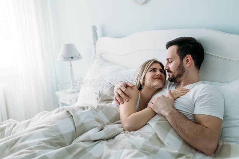 Portrait Of Young Loving Couple In Bedroom Stock P