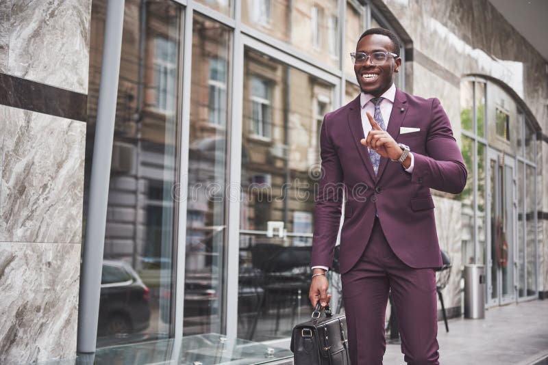 Portrait of a young beautiful African American businessman with a briefcase. Business meeting.