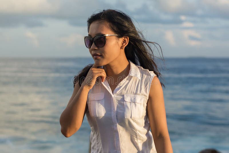 Portrait of a young beautiful asian woman in sunglasses looking a side royalty free stock photo Portrait of a young beautiful asian woman in sunglasses looking a side royalty free stock photo