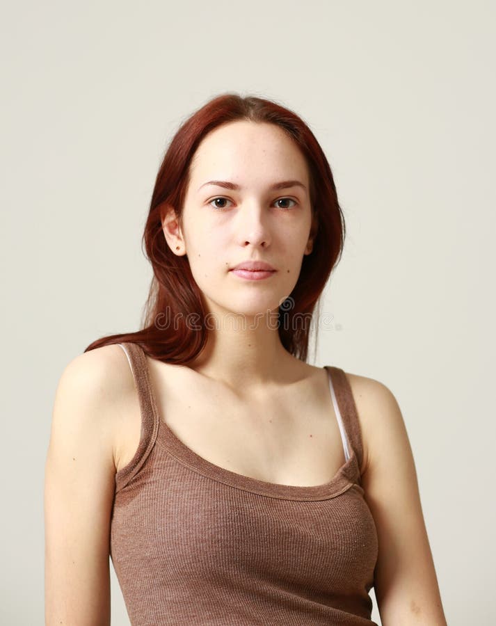 Portrait Of A Young Beautiful Brunette In A Shirt Light Background
