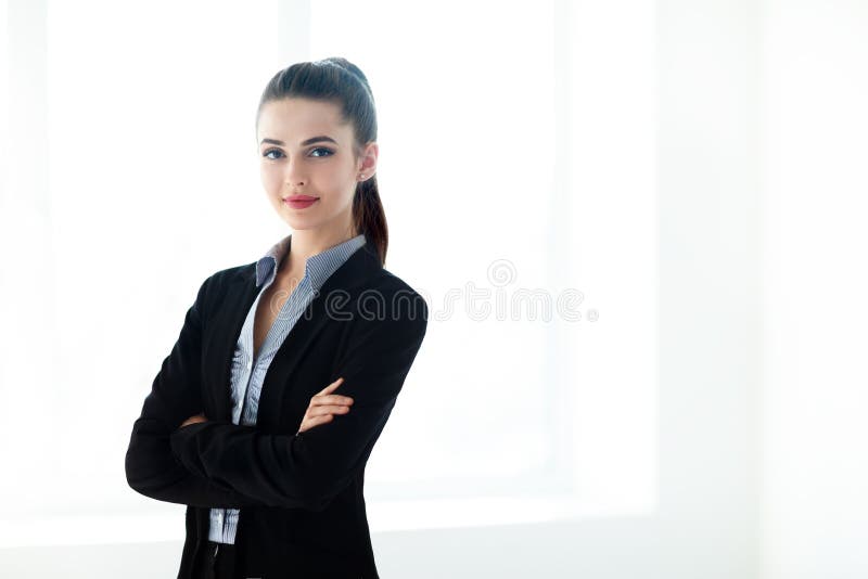 Portrait of young beautiful business woman with crossed arms