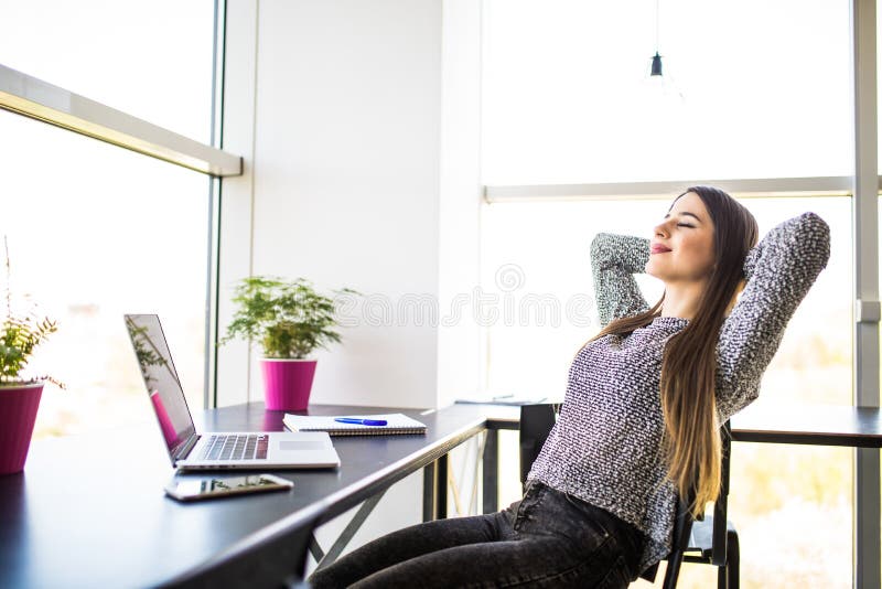 Portrait of young beautiful business woman relaxing at office. stock photography Portrait of young beautiful business woman relaxing at office. stock photography
