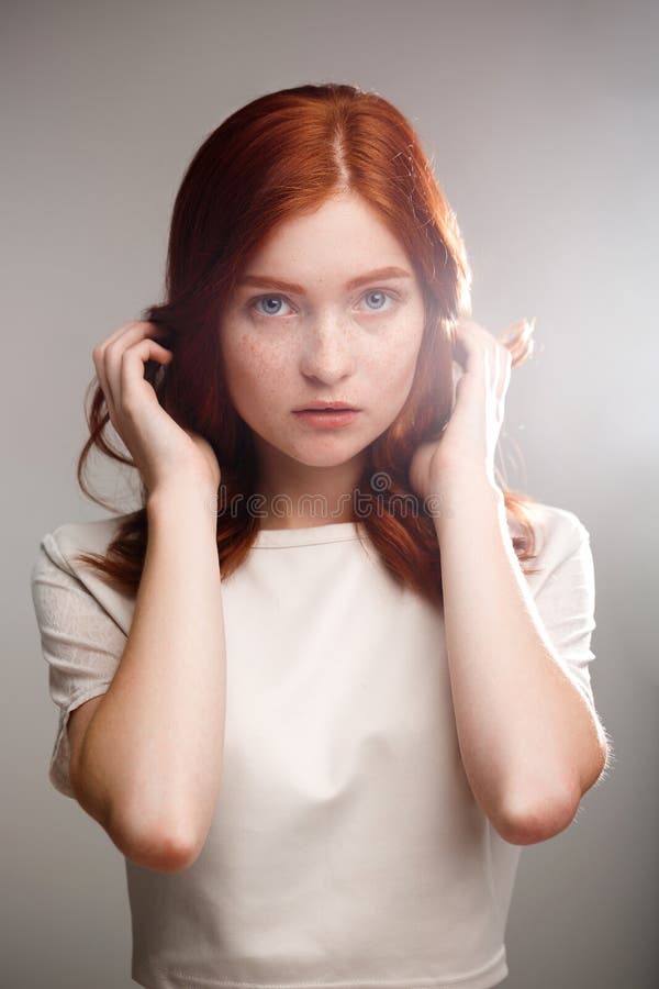 Portrait of Young Beautiful Ginger Girl Over White Background. Stock