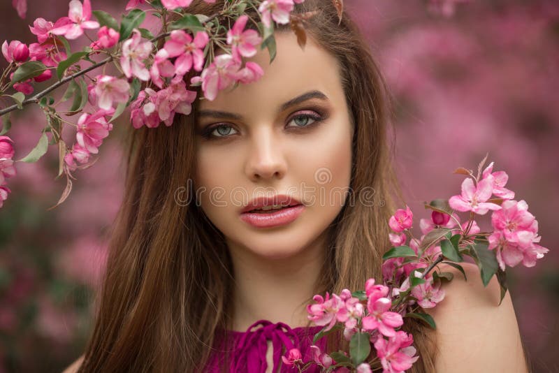 Closeup Romantic Portrait Of Young Beautiful Woman In Blossom Apple Garden With Pink Flowers 