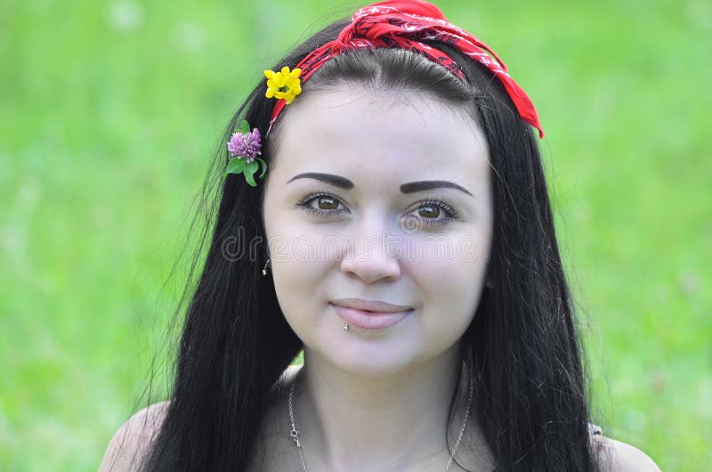 Portrait of a young, beautiful girl, brunette with flowers in her hair and scarf stock photography Portrait of a young, beautiful girl, brunette with flowers in her hair and scarf stock photography