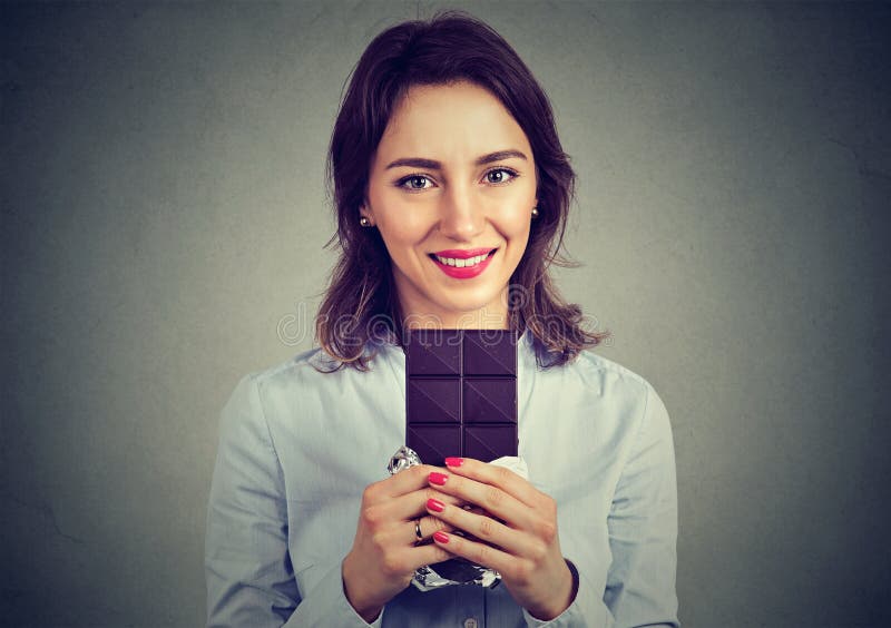 Portrait of a young beautiful girl holding a dark chocolate bar stock photography Portrait of a young beautiful girl holding a dark chocolate bar stock photography