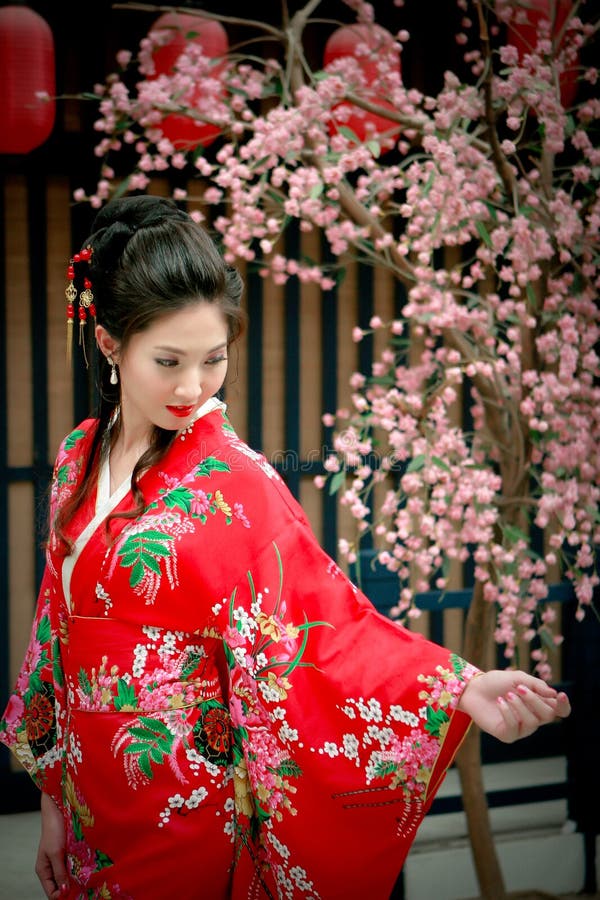 Portrait of young beautiful girl in red kimono