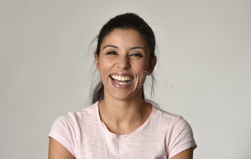 Portrait of young beautiful and happy Latin woman with big toothy smile excited and cheerful