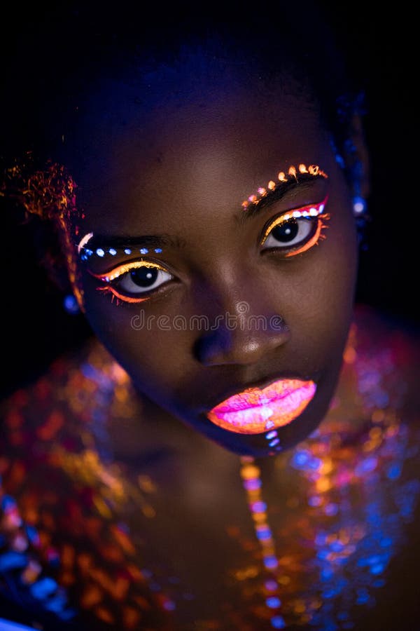 Women Portrait With Glowing Colored Makeup In Black Light Stock