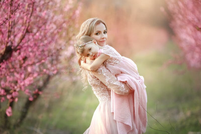 Portrait of young beautiful mother with her little girl. Close up still of loving family. Attractive woman holding her