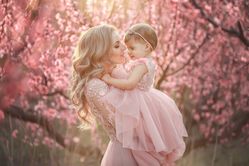 Portrait of young beautiful mother with her little girl. Close up still of loving family. Attractive woman holding her