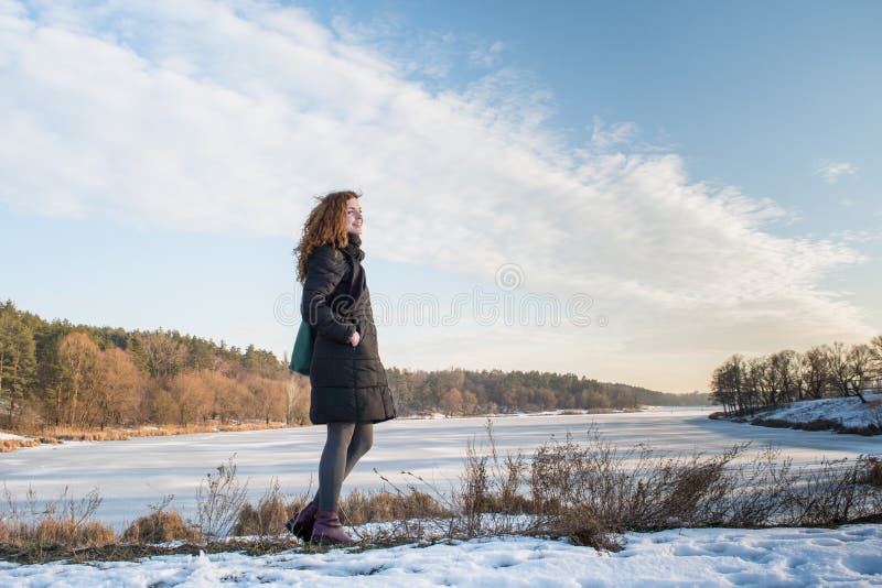 Portrait of a young beautiful red hair european girl catching blowing wind