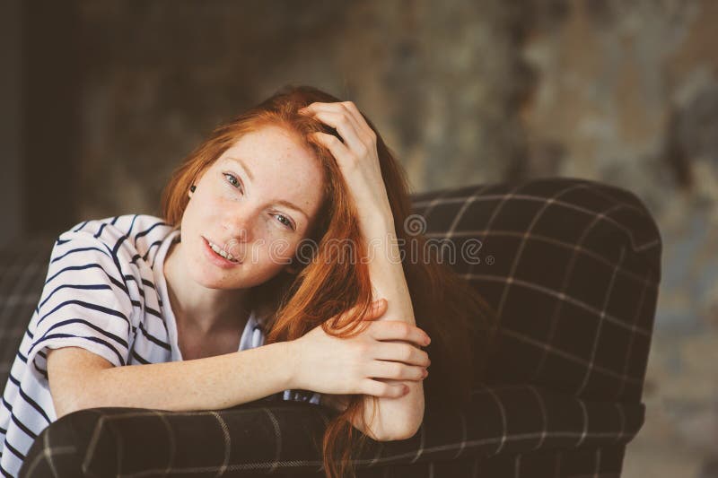 Portrait Of Young Beautiful Redhead Woman Relaxing At Home In The Autumn Ot Winter Cozy Evening 