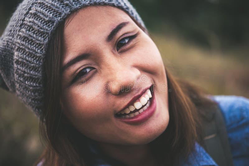 Portrait of young beautiful smile woman in sunset. Vintage filter style. Happy woman in field