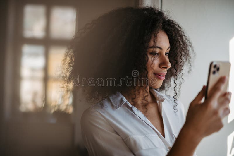 Portrait of young woman using smartphone. royalty free stock photos