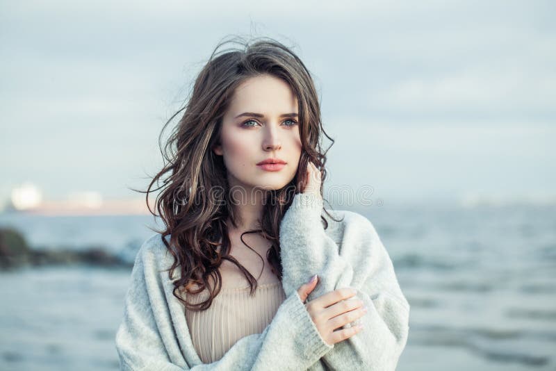 Portrait of young beauty woman with long brown hair outdoor. Romantic vacation
