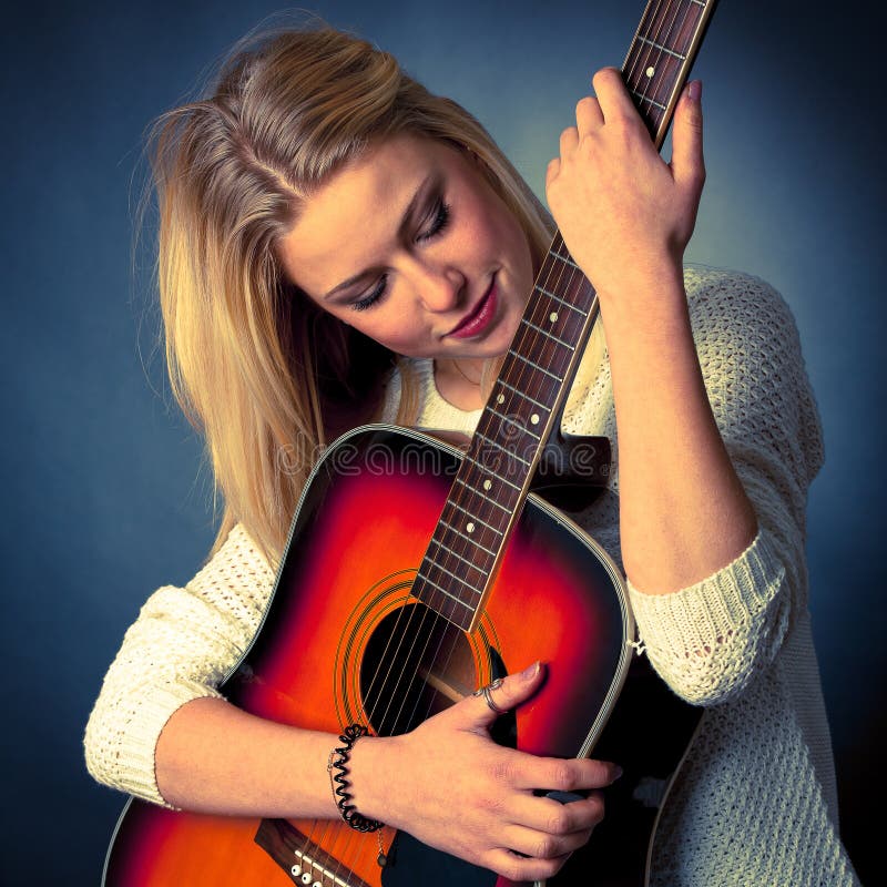 Portrait of young blonde guitar player woman stock photos Portrait of young blonde guitar player woman stock photos