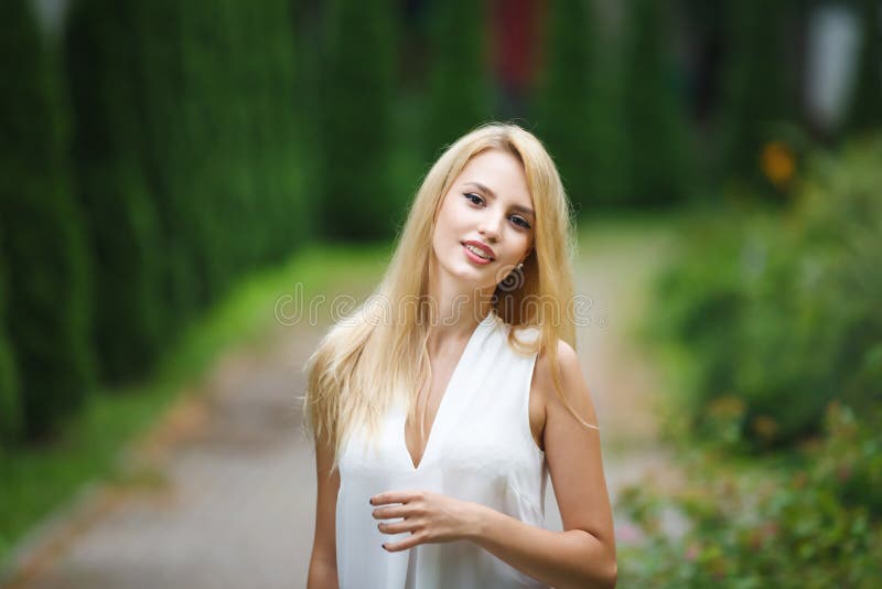 Portrait of young blonde woman. Female, happy.