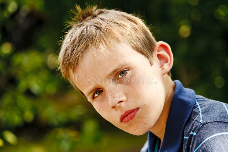 Portrait of a Young Boy Sitting in the Garden Stock Image - Image of ...