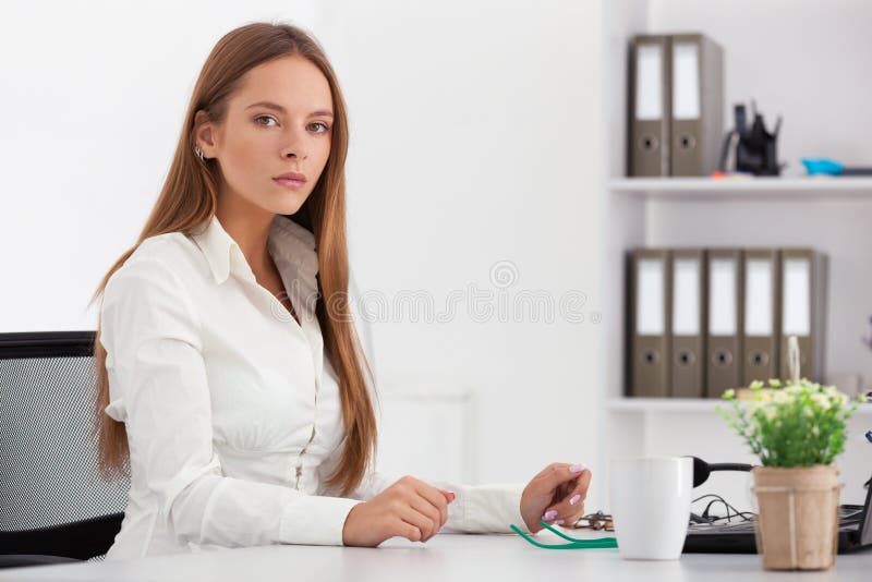 Portrait of young business woman working at her office.