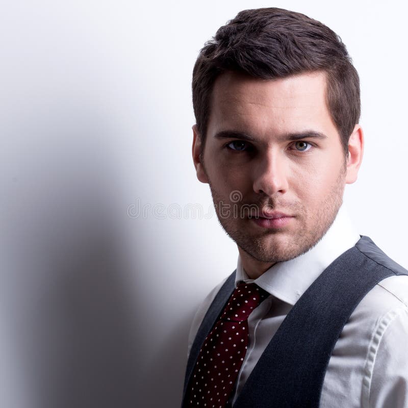 Portrait of young businessman in gray suit.