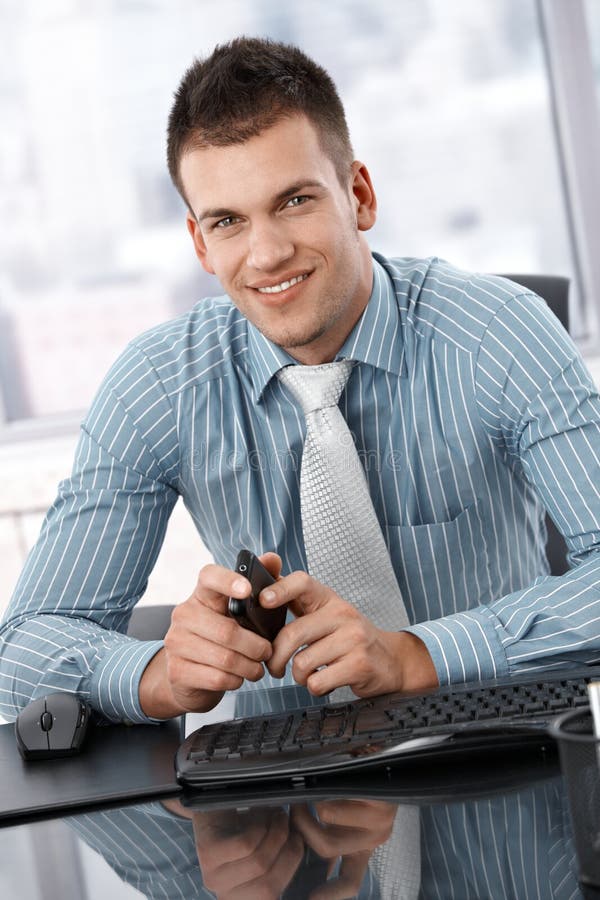 Portrait of Young Businessman Sitting at Desk Stock Image Image of